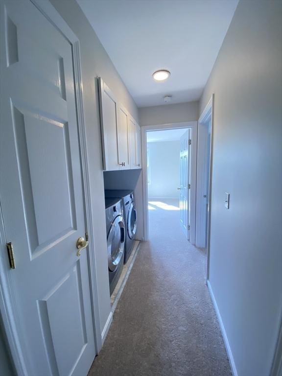 laundry area featuring independent washer and dryer, carpet, cabinet space, and baseboards