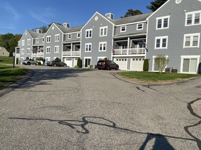 view of asphalt road with a residential view