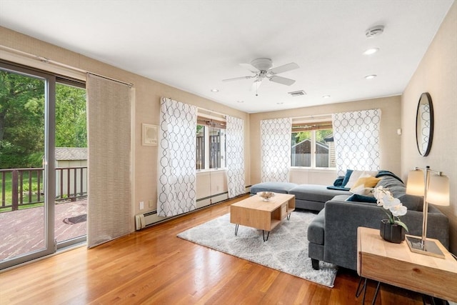 living area featuring wood finished floors, ceiling fan, and recessed lighting