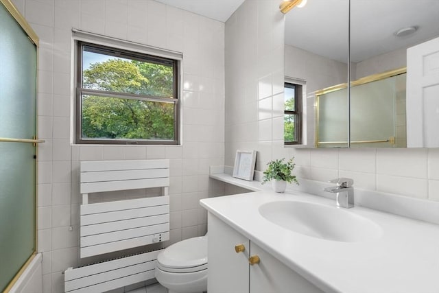 full bath featuring tile walls, vanity, and toilet