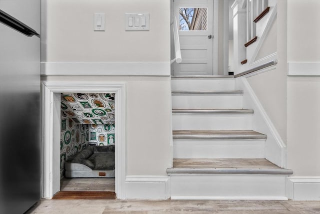 stairway featuring wood finished floors