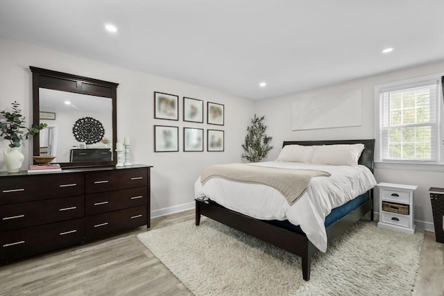 bedroom featuring recessed lighting, baseboards, and light wood-type flooring