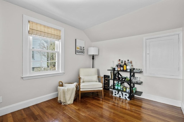 sitting room with baseboards, wood finished floors, and vaulted ceiling