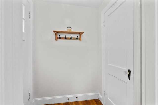 washroom featuring dark wood-style flooring and baseboards