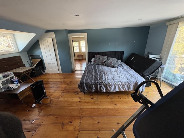 bedroom featuring hardwood / wood-style flooring and lofted ceiling