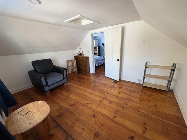 living area featuring wood-type flooring and vaulted ceiling