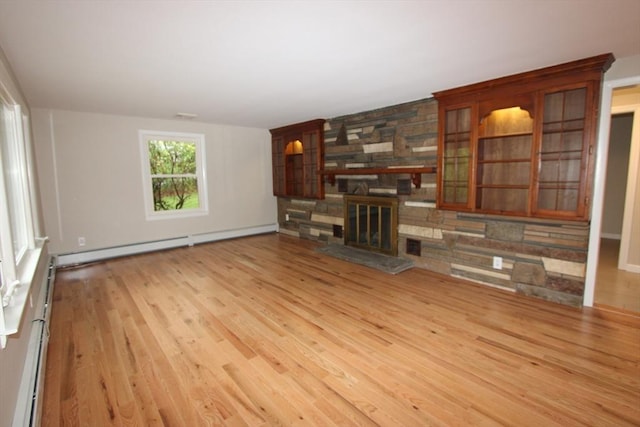 unfurnished living room featuring wood finished floors and a fireplace