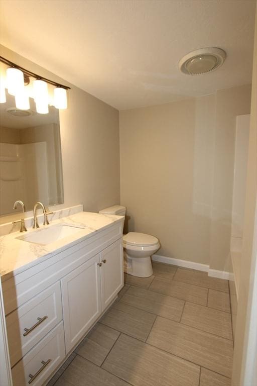 full bath with toilet, vanity, and a shower
