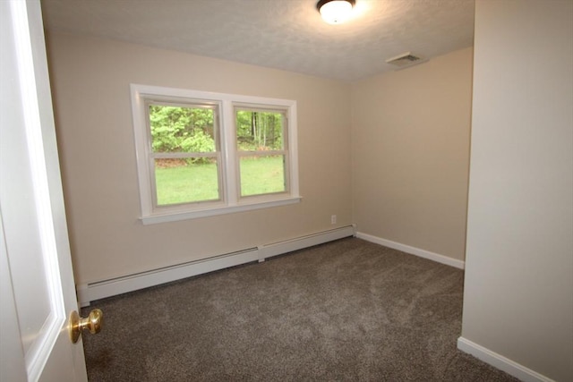 empty room with baseboard heating, carpet floors, and baseboards