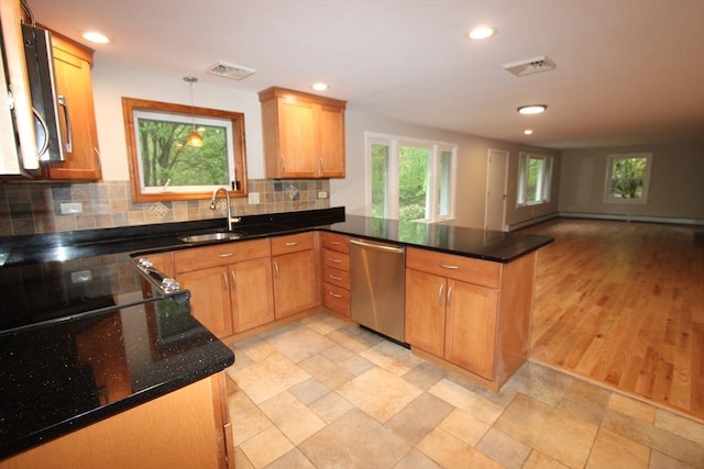 kitchen with dishwasher, a peninsula, a sink, backsplash, and recessed lighting