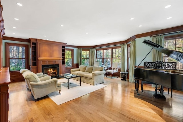 living room featuring crown molding and light wood-type flooring