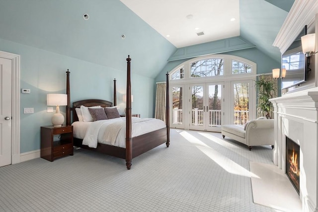 bedroom featuring french doors, light colored carpet, lofted ceiling, and access to exterior