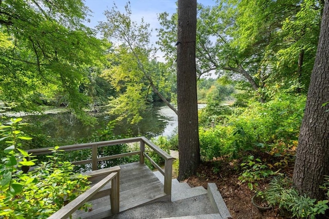 wooden terrace featuring a water view