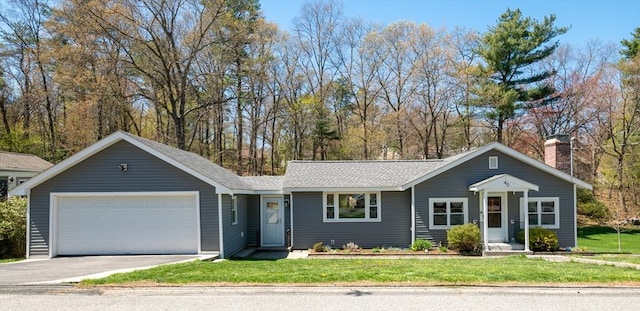 ranch-style home with driveway, a chimney, a front yard, and a garage