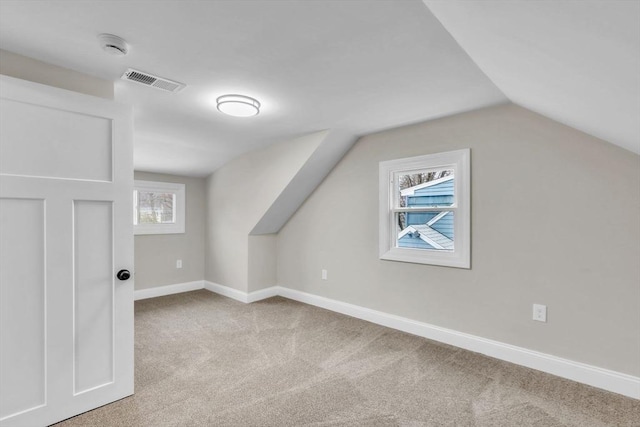 bonus room featuring light colored carpet and lofted ceiling