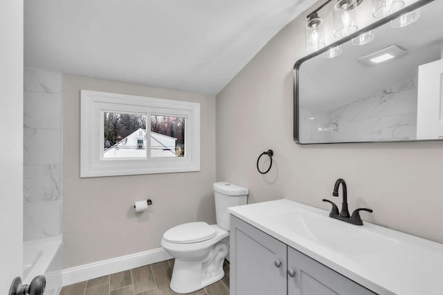 full bathroom with vanity, vaulted ceiling,  shower combination, and toilet