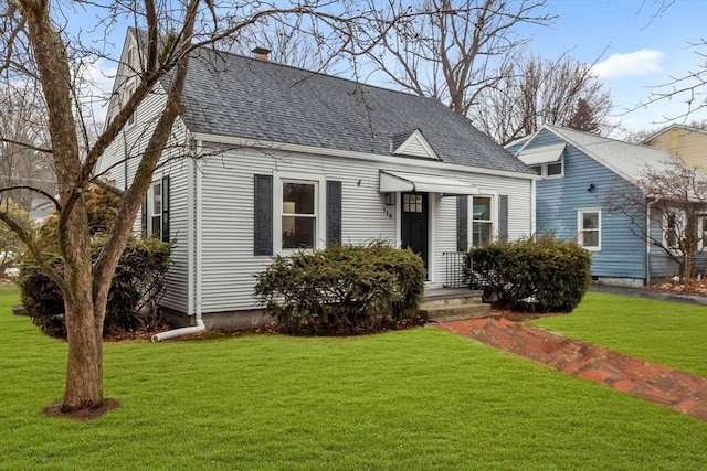 cape cod house featuring a front lawn