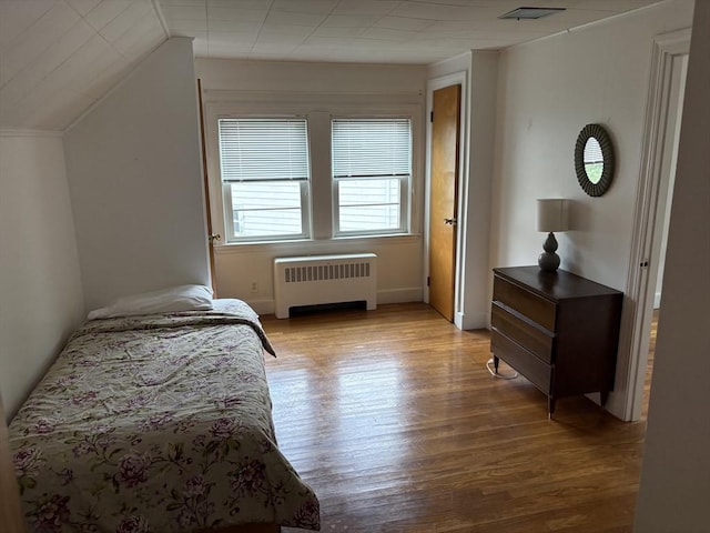 33 Meadowbrook Rd, Brookline, MA 02467 - bedroom featuring radiator heating unit, light wood-style flooring, and lofted ceiling