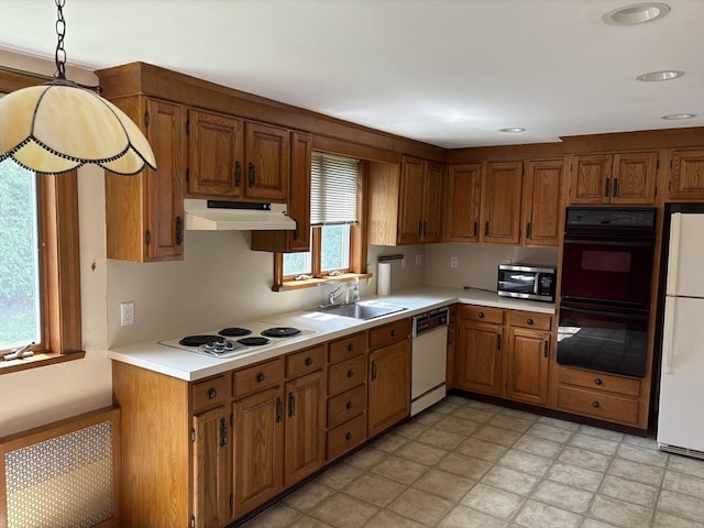 33 Meadowbrook Rd, Brookline, MA 02467 - kitchen featuring white appliances, under cabinet range hood, light countertops, brown cabinets, and recessed lighting