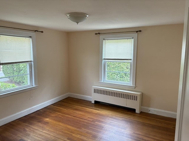 33 Meadowbrook Rd, Brookline, MA 02467 - empty room with radiator heating unit and wood finished floors