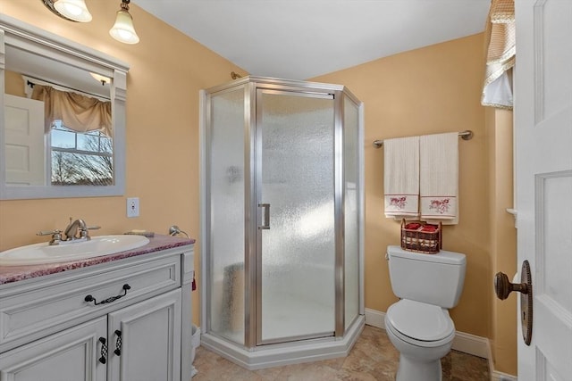 bathroom featuring vanity, toilet, tile patterned floors, and walk in shower