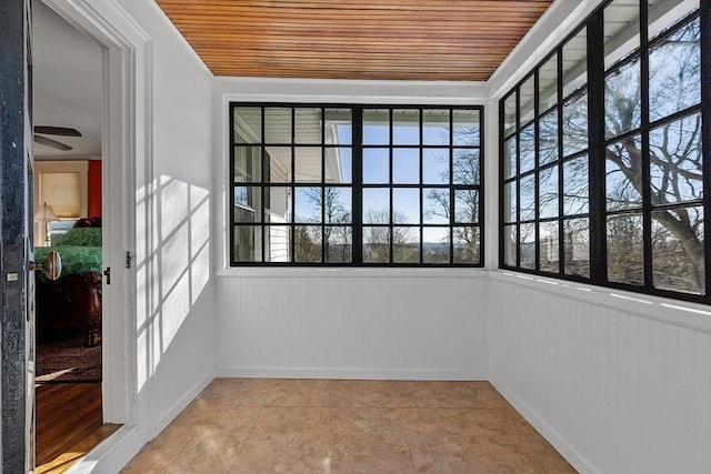 unfurnished sunroom with wood ceiling and plenty of natural light