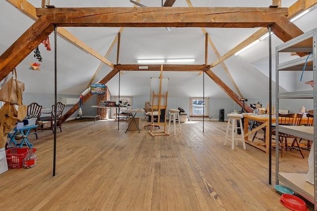 interior space with vaulted ceiling and light hardwood / wood-style flooring