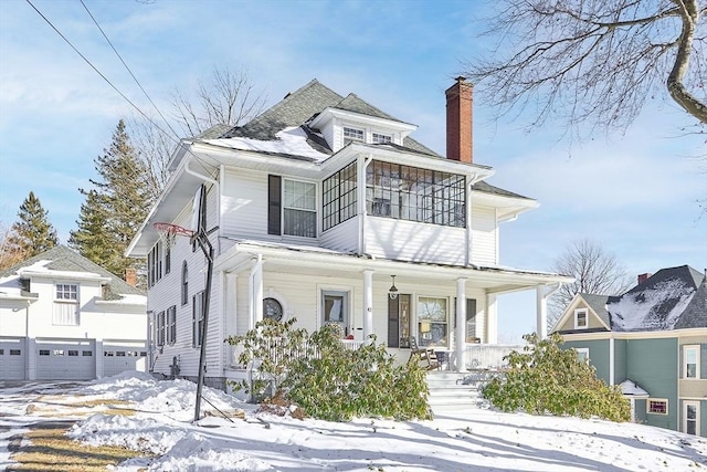 view of front of property with a garage and covered porch