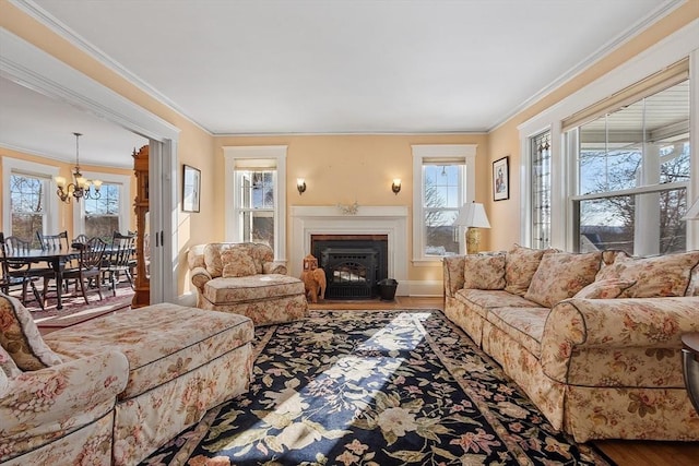 living room with hardwood / wood-style flooring, crown molding, and a notable chandelier