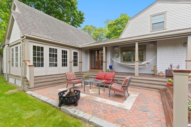15 Hawthorne Rd, Hingham, MA 02043 - back of house featuring french doors, roof with shingles, a patio, an outdoor living space with a fire pit, and a gambrel roof
