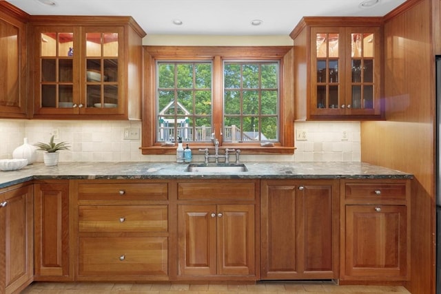 15 Hawthorne Rd, Hingham, MA 02043 - kitchen featuring a sink, dark stone counters, glass insert cabinets, and brown cabinetry
