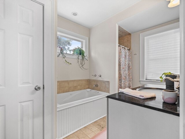 bathroom featuring a tub to relax in and sink