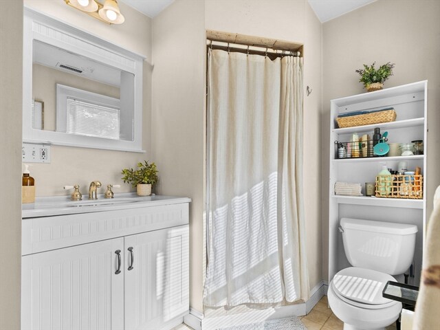 bathroom featuring tile patterned floors, vanity, and toilet