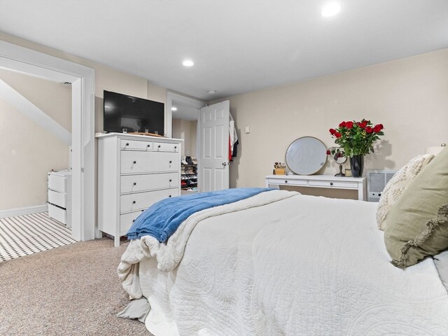 bedroom with carpet floors and an AC wall unit