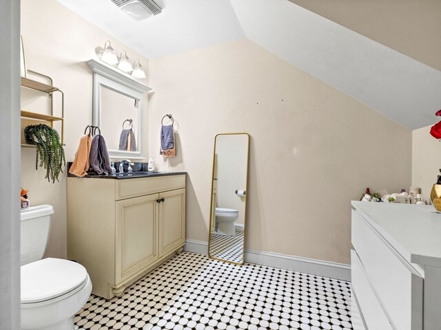 bathroom featuring vaulted ceiling, vanity, and toilet