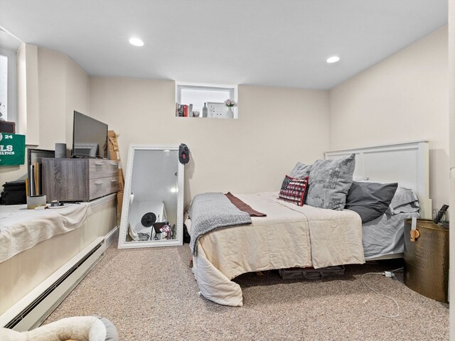 carpeted bedroom with baseboard heating