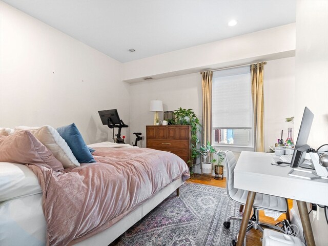 bedroom with wood-type flooring