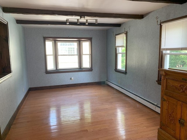 19 Locust Ave, Southbridge, MA 01550 - empty room featuring a baseboard heating unit, beamed ceiling, and light wood-style flooring