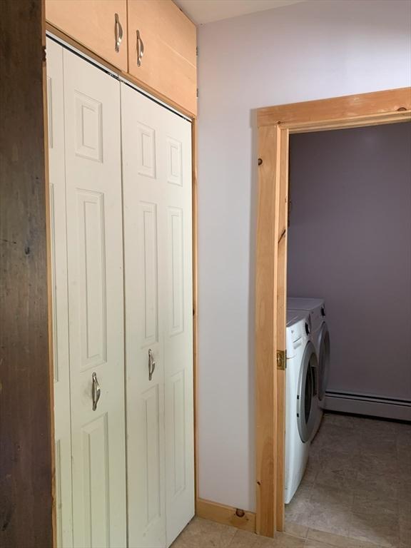 19 Locust Ave, Southbridge, MA 01550 - laundry area with baseboard heating, washer and clothes dryer, and cabinet space