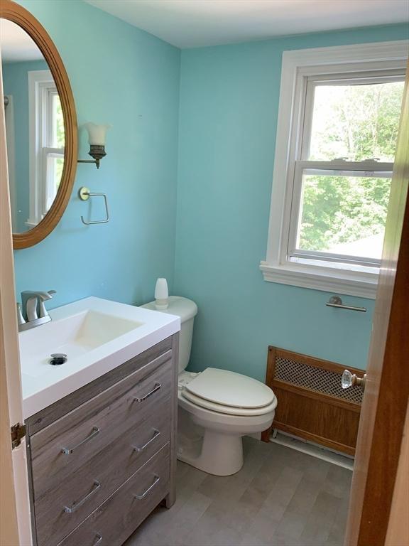 19 Locust Ave, Southbridge, MA 01550 - half bath featuring vanity and radiator heating unit