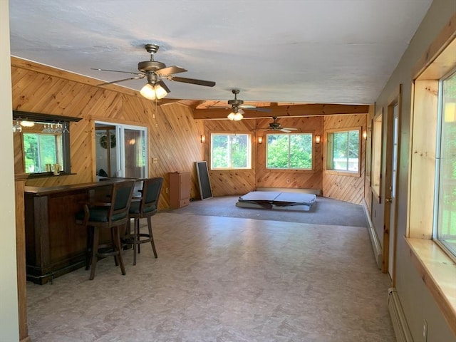 19 Locust Ave, Southbridge, MA 01550 - living room with wooden walls, tile patterned floors, a ceiling fan, and a bar
