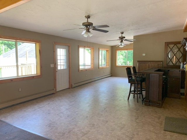 19 Locust Ave, Southbridge, MA 01550 - kitchen featuring baseboard heating, light floors, ceiling fan, and a kitchen breakfast bar