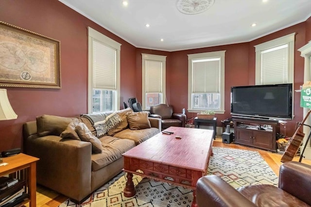 living area featuring crown molding, recessed lighting, and light wood-style floors