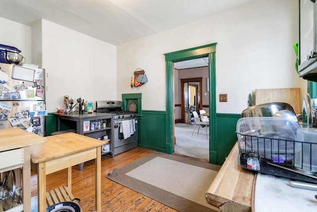 interior space featuring a wainscoted wall and wood finished floors