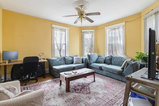 living room with a ceiling fan and wood finished floors