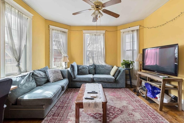 living room with a ceiling fan and wood finished floors