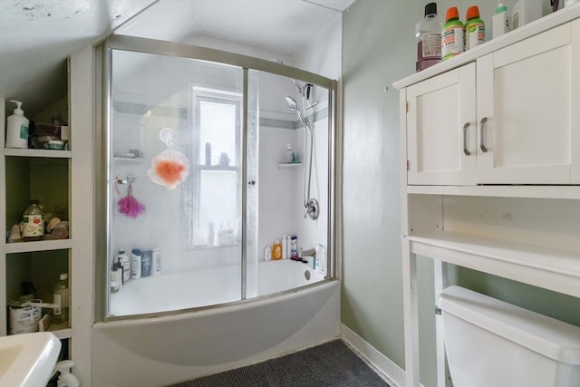full bath featuring vaulted ceiling, combined bath / shower with glass door, and toilet
