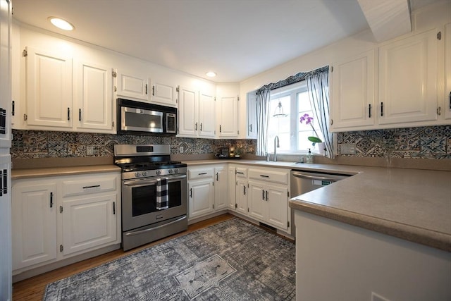 38 Nature View Dr Unit 38, Uxbridge, MA 01569 - kitchen with stainless steel appliances, white cabinetry, decorative backsplash, and recessed lighting