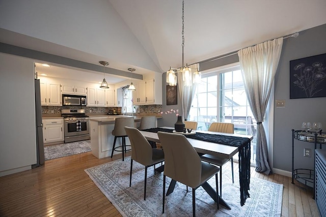 38 Nature View Dr Unit 38, Uxbridge, MA 01569 - dining space with vaulted ceiling, a chandelier, and hardwood / wood-style floors