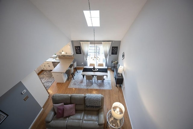 38 Nature View Dr Unit 38, Uxbridge, MA 01569 - living area with wood finished floors, a chandelier, and vaulted ceiling